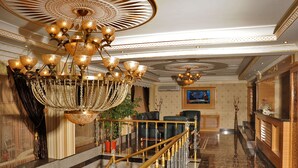 A grand lobby with a chandelier, marble floors, and a reception desk. - Alfa Hotel (Istanbul)