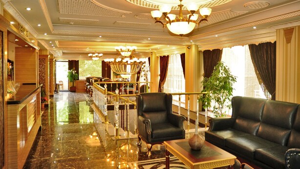 A luxurious lobby with a grand chandelier, plush seating, and a polished marble floor. - Alfa Hotel (Istanbul)