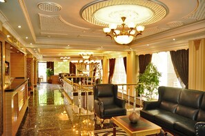 A luxurious lobby with a grand chandelier, plush seating, and a polished marble floor. - Alfa Hotel (Istanbul)