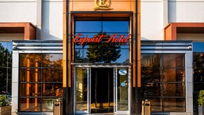 A hotel entrance with a glass facade, a prominent 'Expoist Hotel' sign, and a logo above the entrance. - Expoist Hotel (Istanbul)