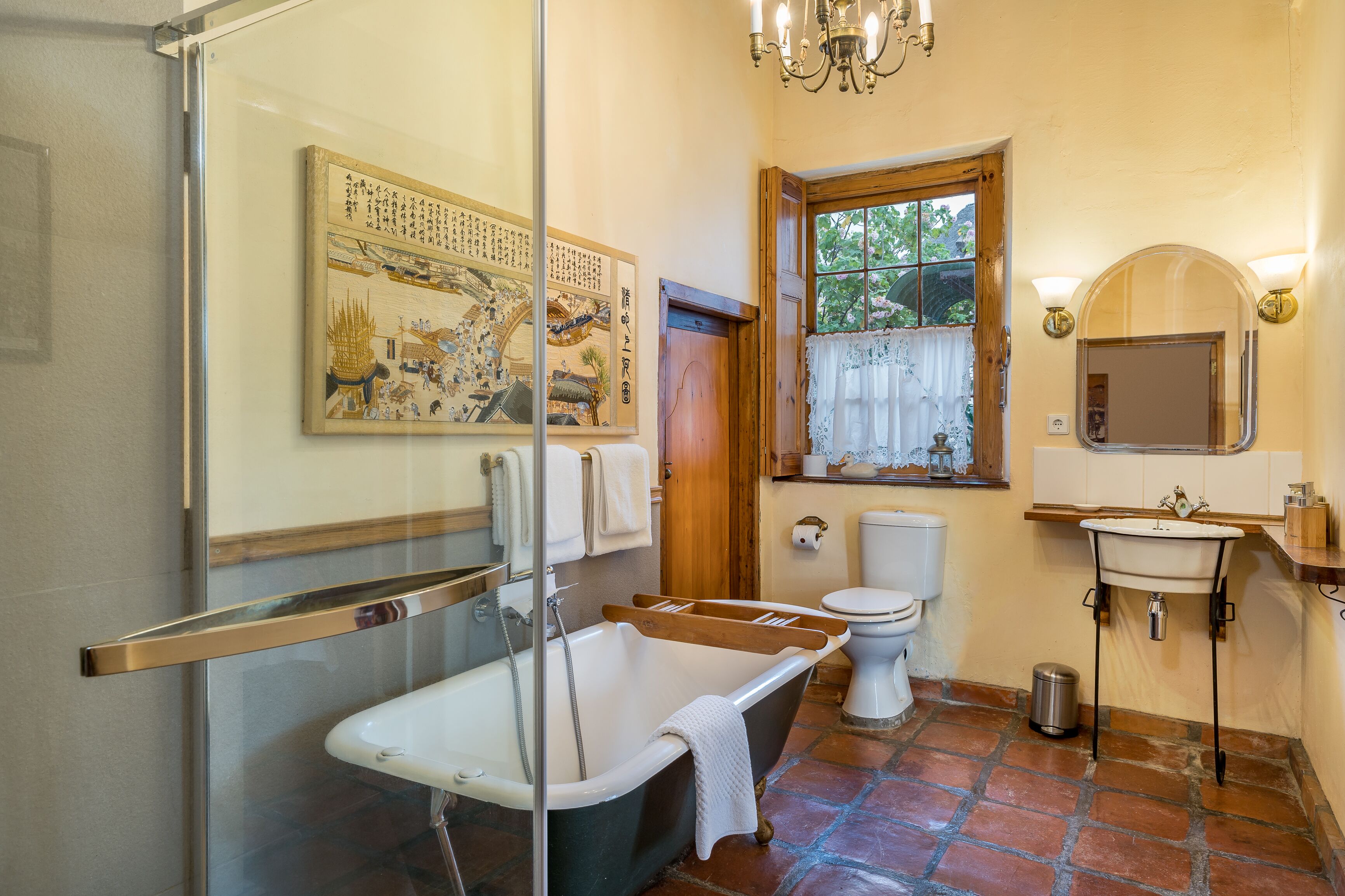 A traditional Japanese-style bathroom with a bathtub, toilet, and sink.