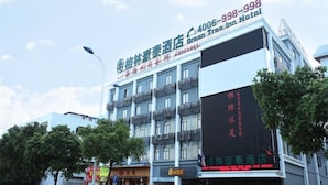 A hotel with multiple floors and balconies, featuring signage for the Green Tree Inn Hotel and a parking sign. - GreenTree Inn Guangzhou Panyu Bus Station Business Hotel (Guangzhou)