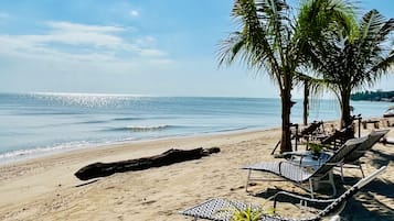 On the beach, sun loungers, beach umbrellas, beach towels