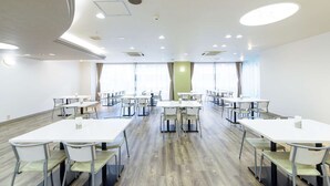 A conference room with multiple tables and chairs, large windows, and a modern ceiling design. - Shin Osaka Hotel (Osaka)