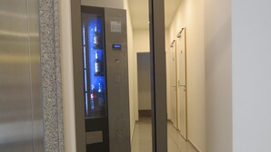 A modern elevator with a digital display and emergency exit sign. - Hotel Neuthor (Ulm)