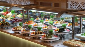 A buffet with various food items displayed on plates and trays. - Orange County Kemer (Kemer)