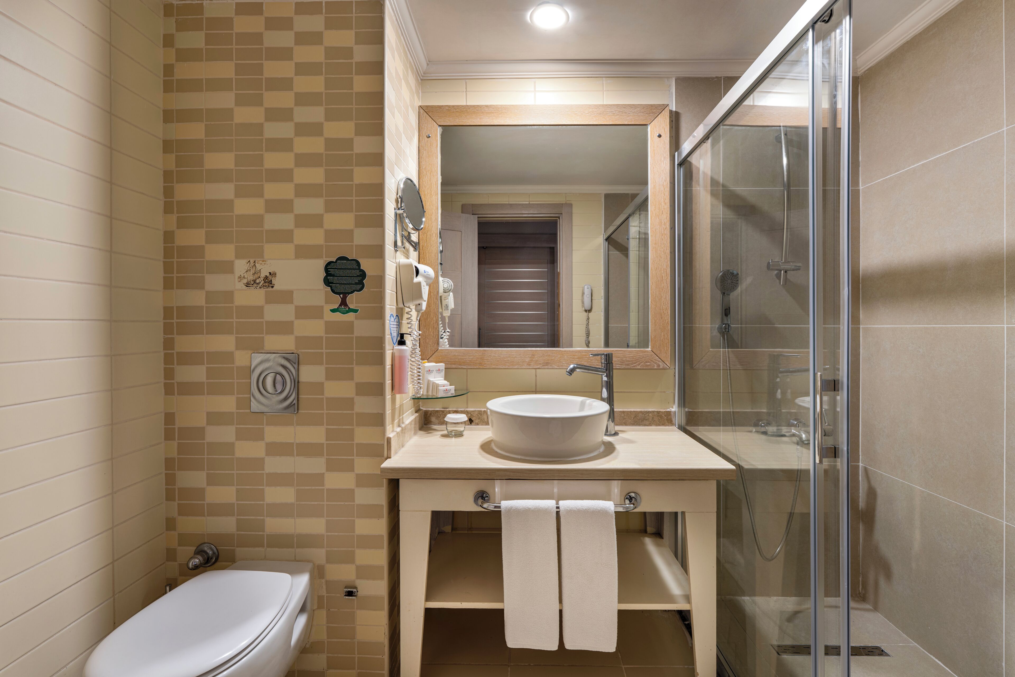 A bathroom with a toilet, sink, and shower.