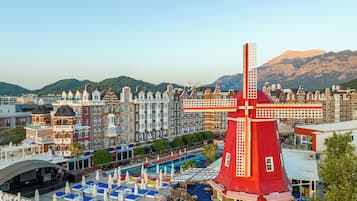 Experience the charm of our hotel, set amidst a traditional architecture with a unique windmill landmark and a rooftop pool area offering sun loungers and umbrellas.
