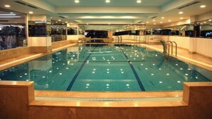 A large indoor swimming pool with multiple lanes, surrounded by walls with glass panels and mirrors. - Hurry Inn Merter Istanbul (Istanbul)