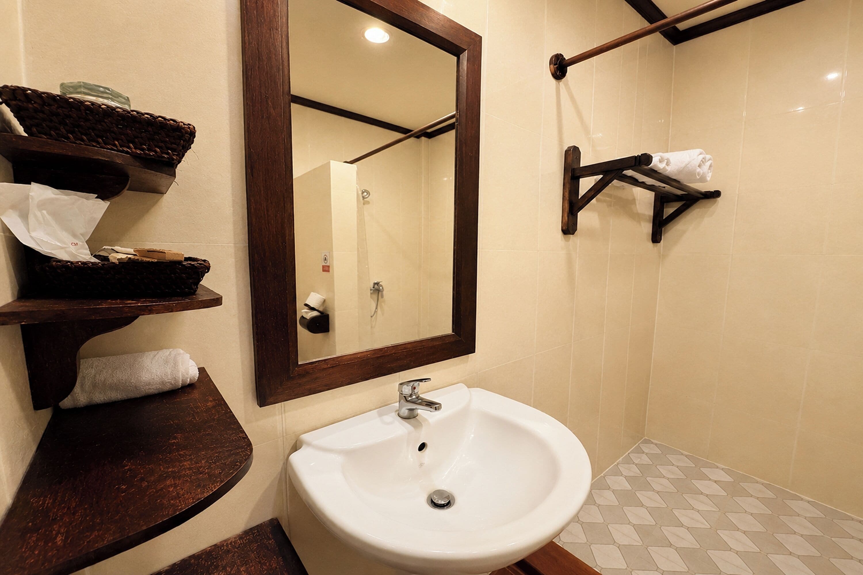 A bathroom with a white sink, a mirror, and a towel rack.
