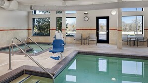 A pool area with a clear view of the pool, a blue chair, and a clock on the wall.