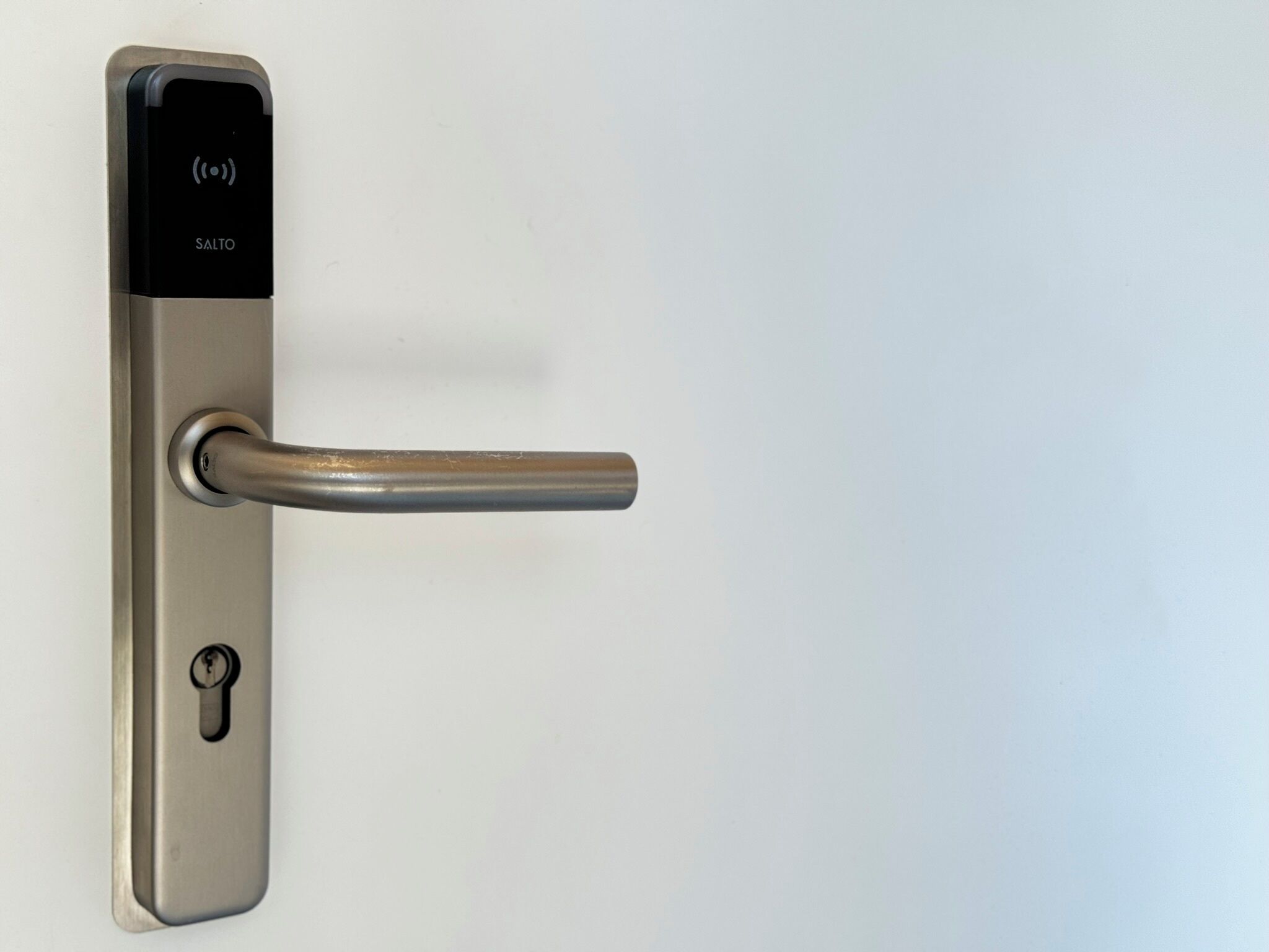 A modern door with a keyhole and a digital lock panel.