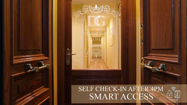 A hotel entrance with a self-check-in after 4 PM feature and smart access. - DG Prestige Room (Rome)
