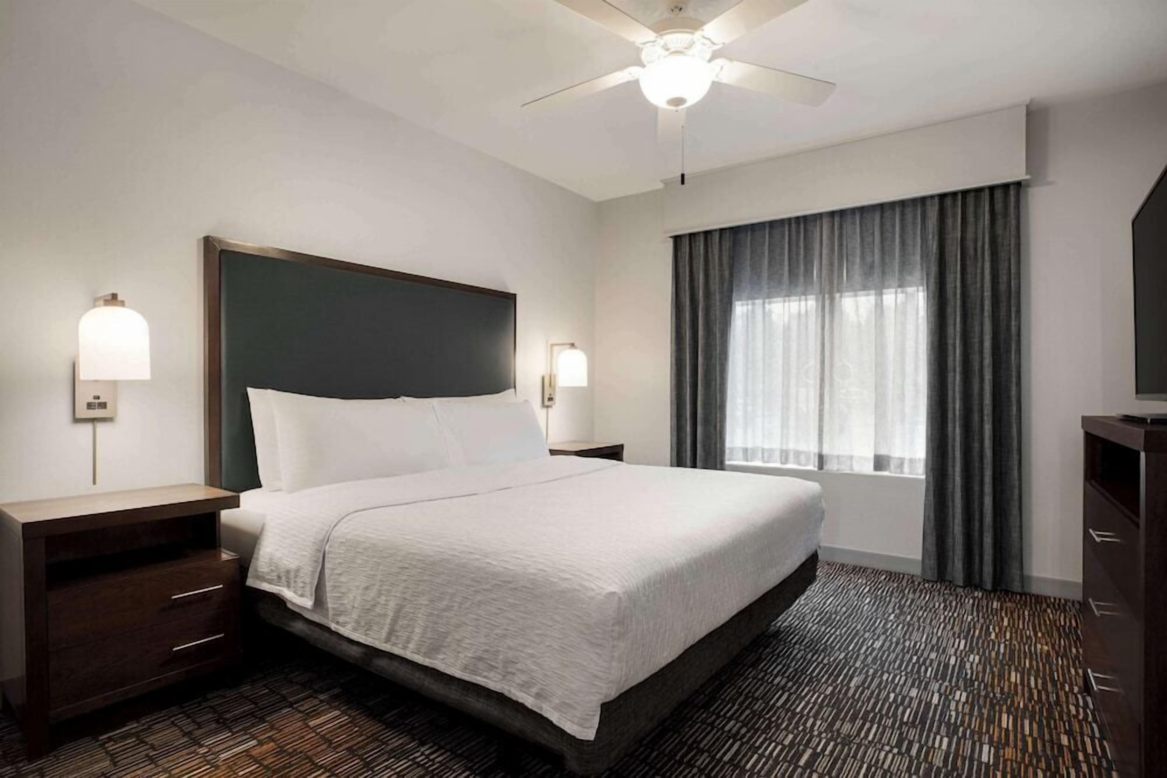 Premium bedding, desk, laptop workspace, blackout curtains