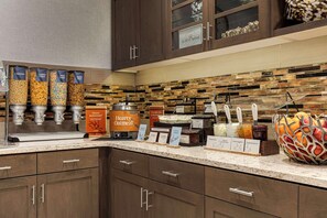 A buffet area with various food options and a decorative fruit bowl. - Homewood Suites by Hilton Charlottesville, VA (Charlottesville)