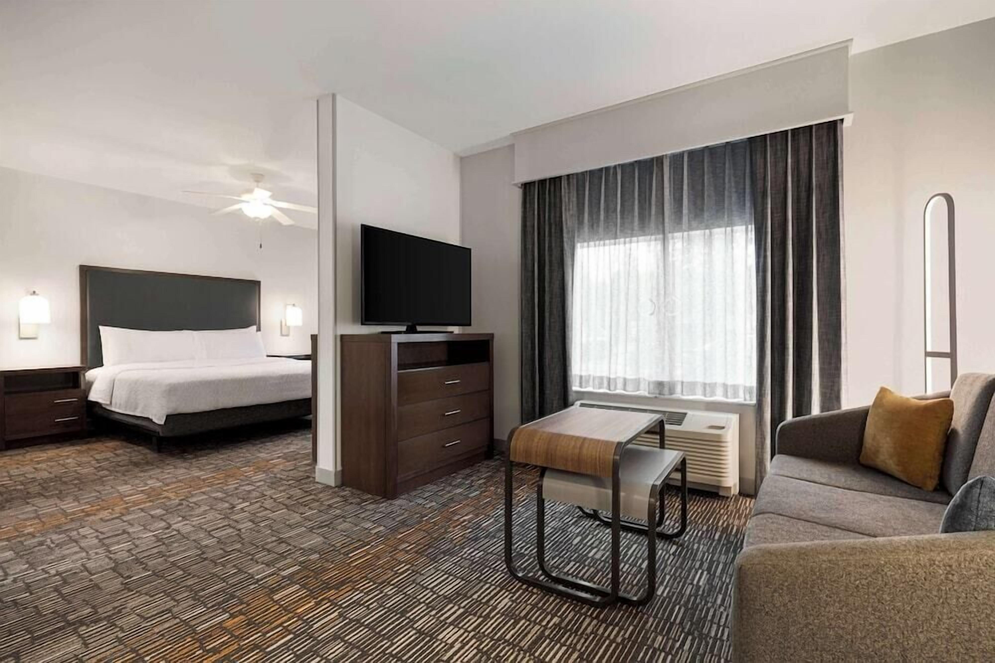 Premium bedding, desk, laptop workspace, blackout curtains