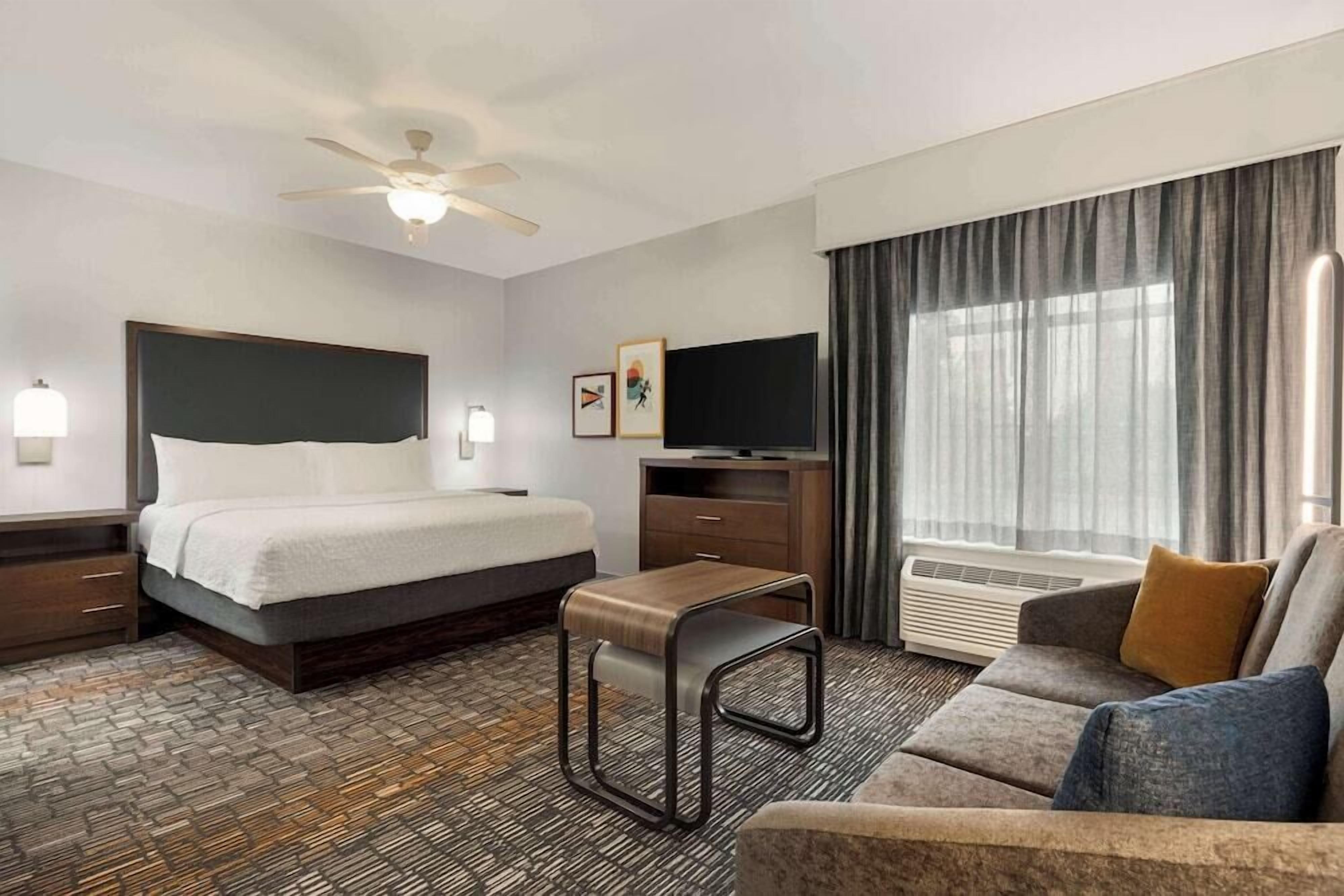Premium bedding, desk, laptop workspace, blackout curtains