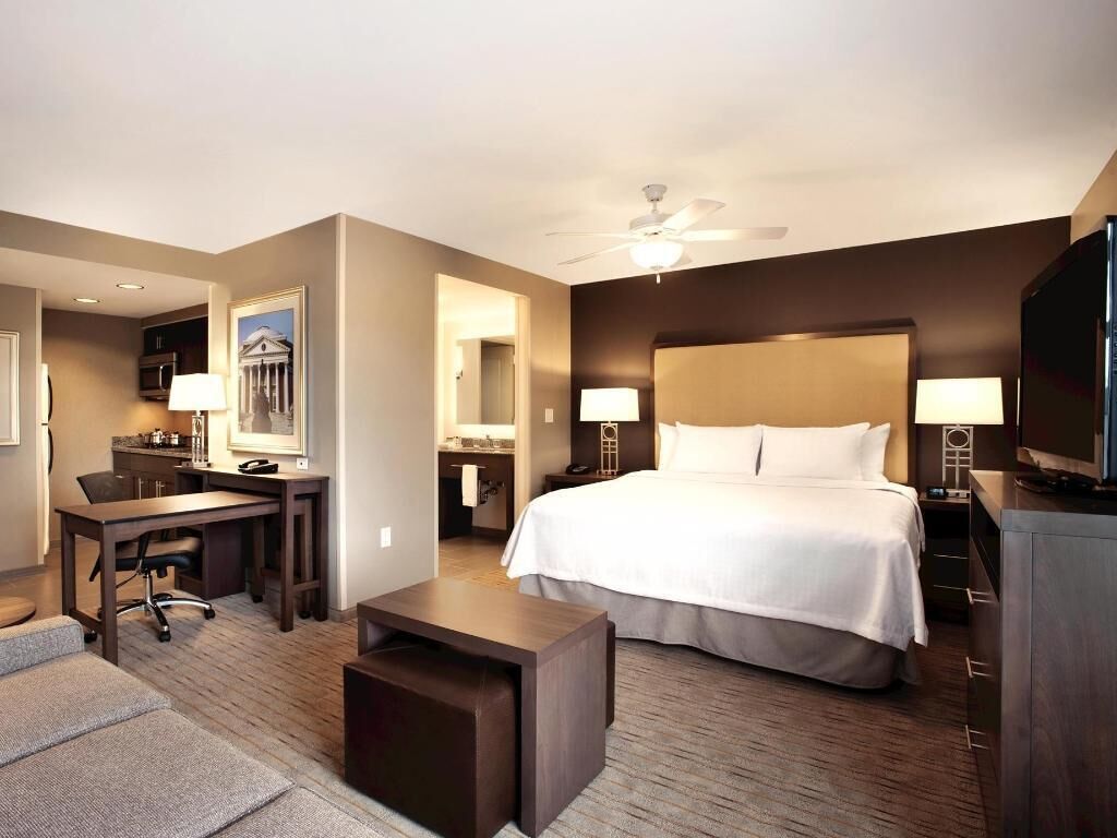 Premium bedding, desk, laptop workspace, blackout curtains