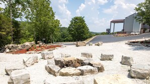 A historical site with ruins and a modern building in the background. - Rosebud Inn (Branson)