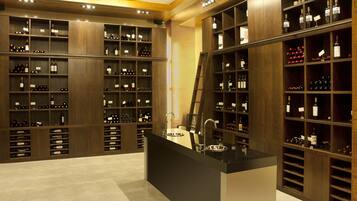 A wine cellar with wooden shelves and a central tasting area.