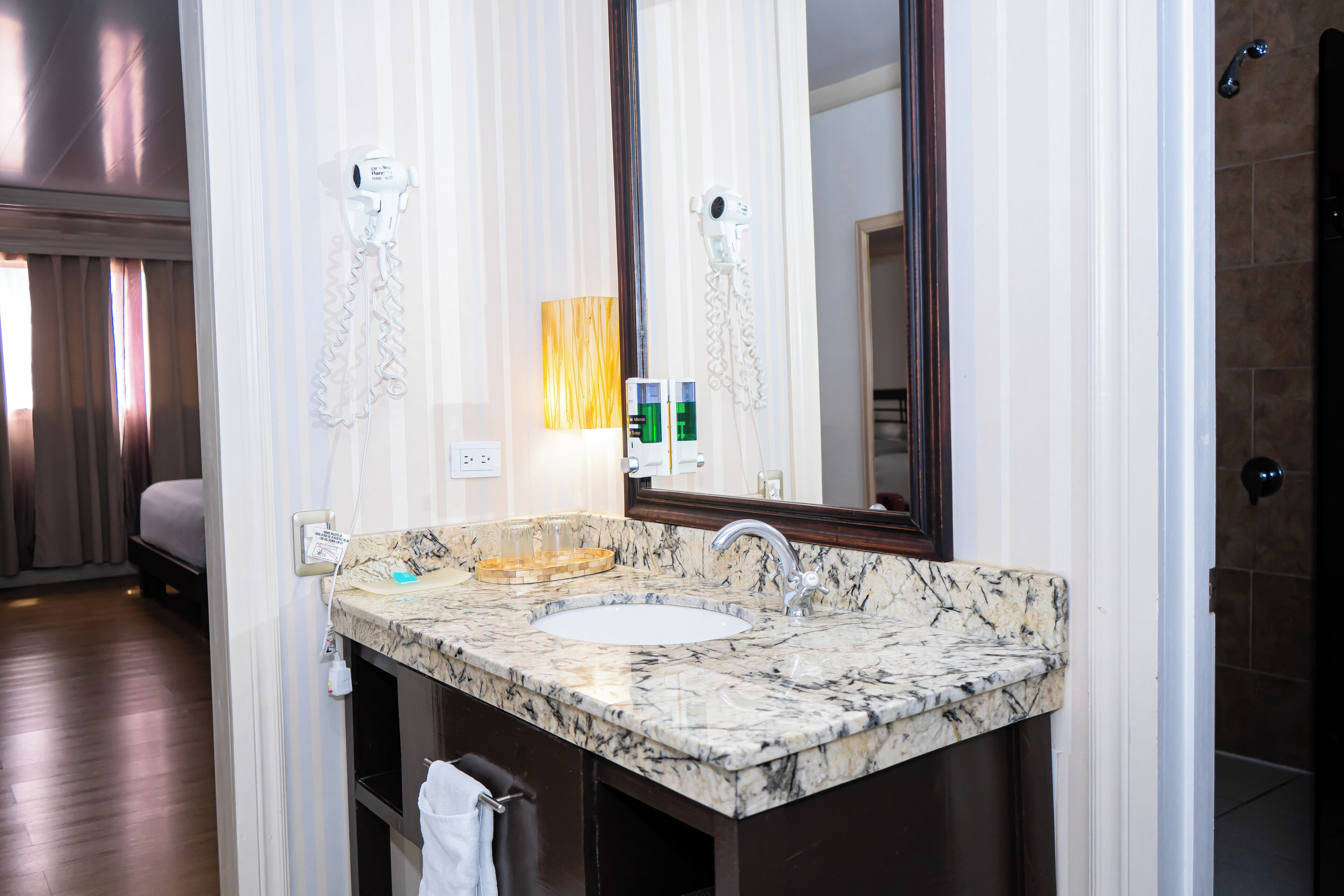 junior room, 2 queen beds | bathroom | shower, designer toiletries, hair dryer, towels