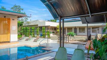 Outdoor pool, open 7:00 AM to 9:00 PM, pool loungers