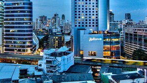 A high-rise hotel with a modern design, featuring a prominent Radisson logo. - Radisson Blu Plaza Bangkok (Bangkok)