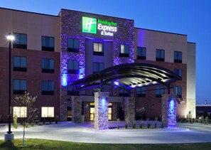 A Holiday Inn Express & Suites hotel with a modern architectural design, featuring a prominent illuminated sign and a covered entrance area. - Holiday Inn Express Hotel & Suites Fort Dodge by IHG (Fort Dodge)