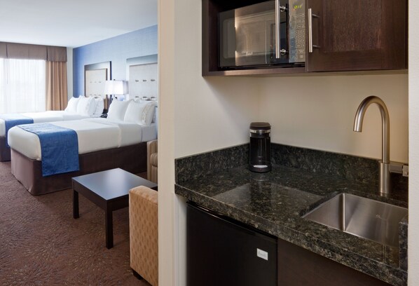 A hotel room with two beds, a small table, a coffee maker, a microwave, and a sink. - Holiday Inn Express Hotel & Suites Fort Dodge by IHG (Fort Dodge)