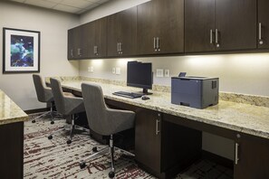 A modern office space with a desk, two chairs, a computer, and a printer. - Hilton Garden Inn Washington DC/Georgetown Area (Washington)
