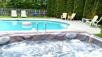 Relax by the pool and hot tub in this serene outdoor oasis.