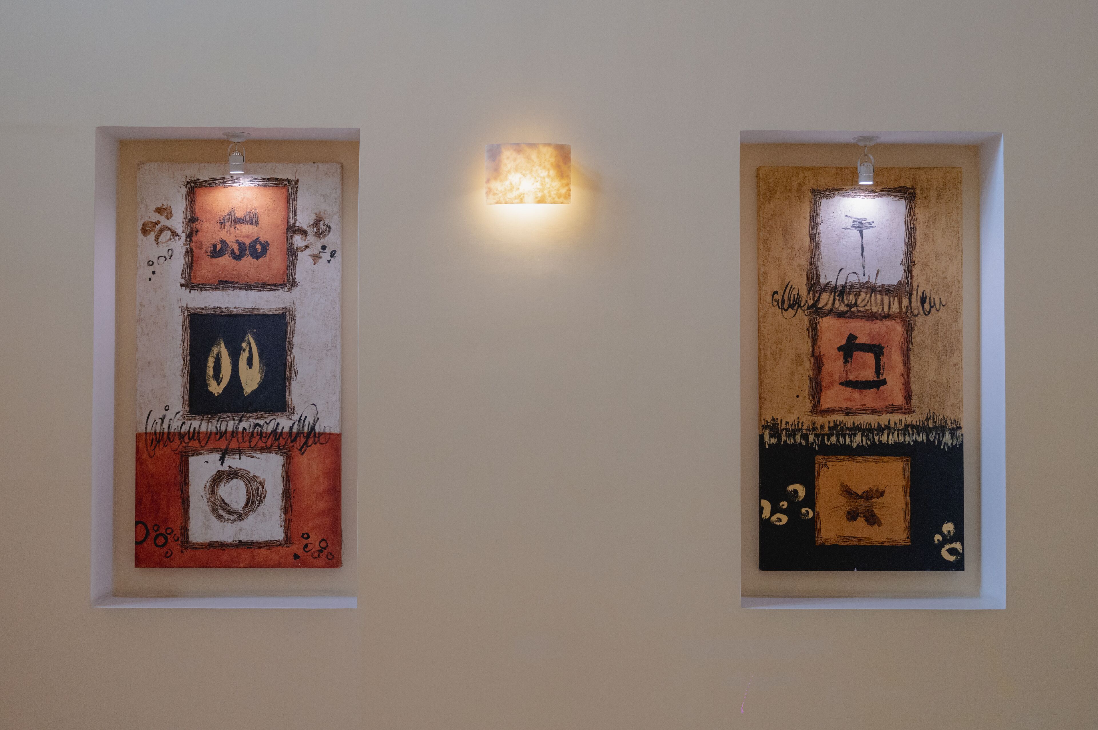 Two framed artworks on a wall.