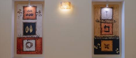 Two framed artworks on a wall.