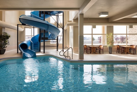 Una piscina techada, sillones reclinables de piscina