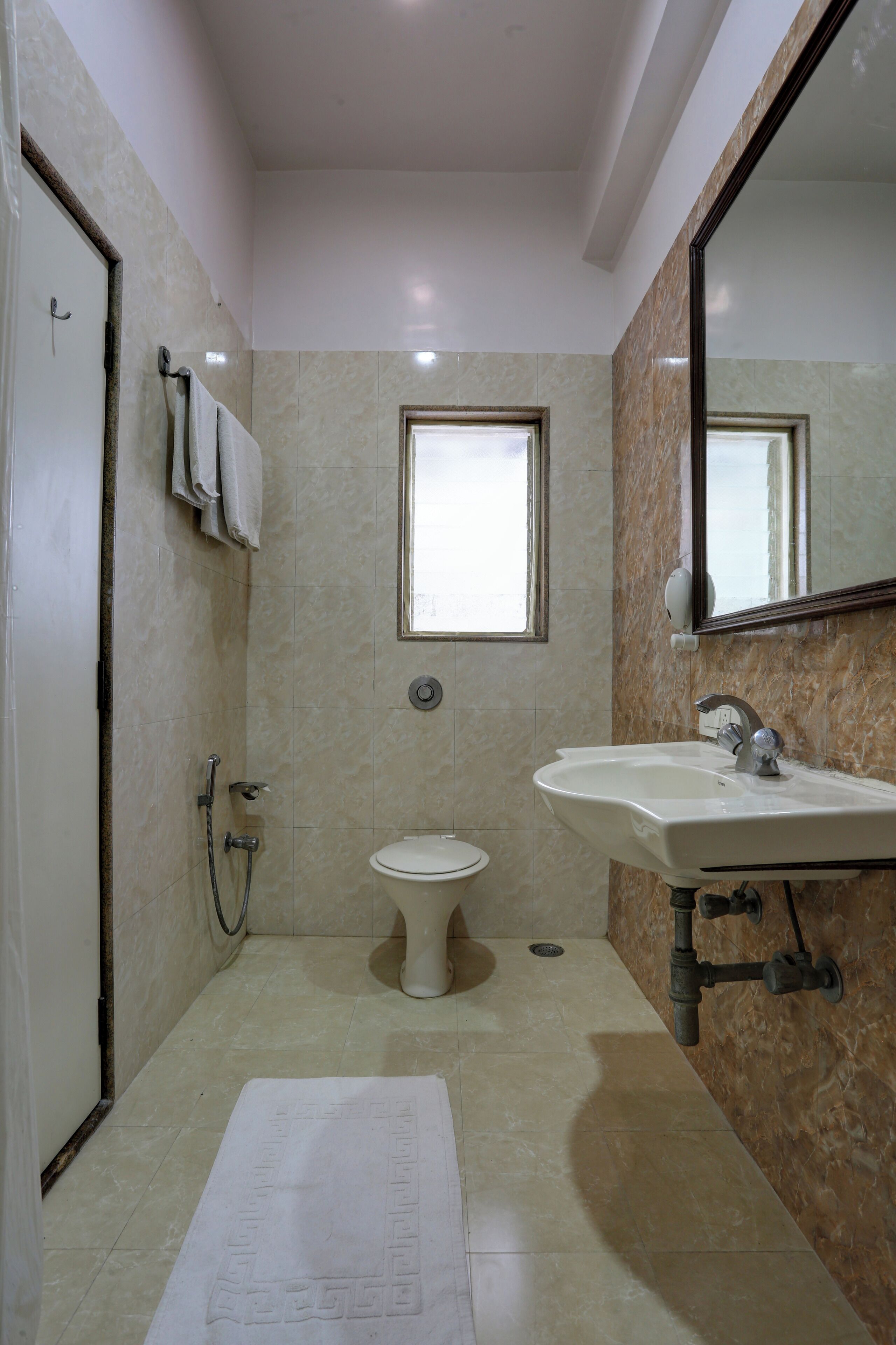 A bathroom with a toilet, sink, and shower.