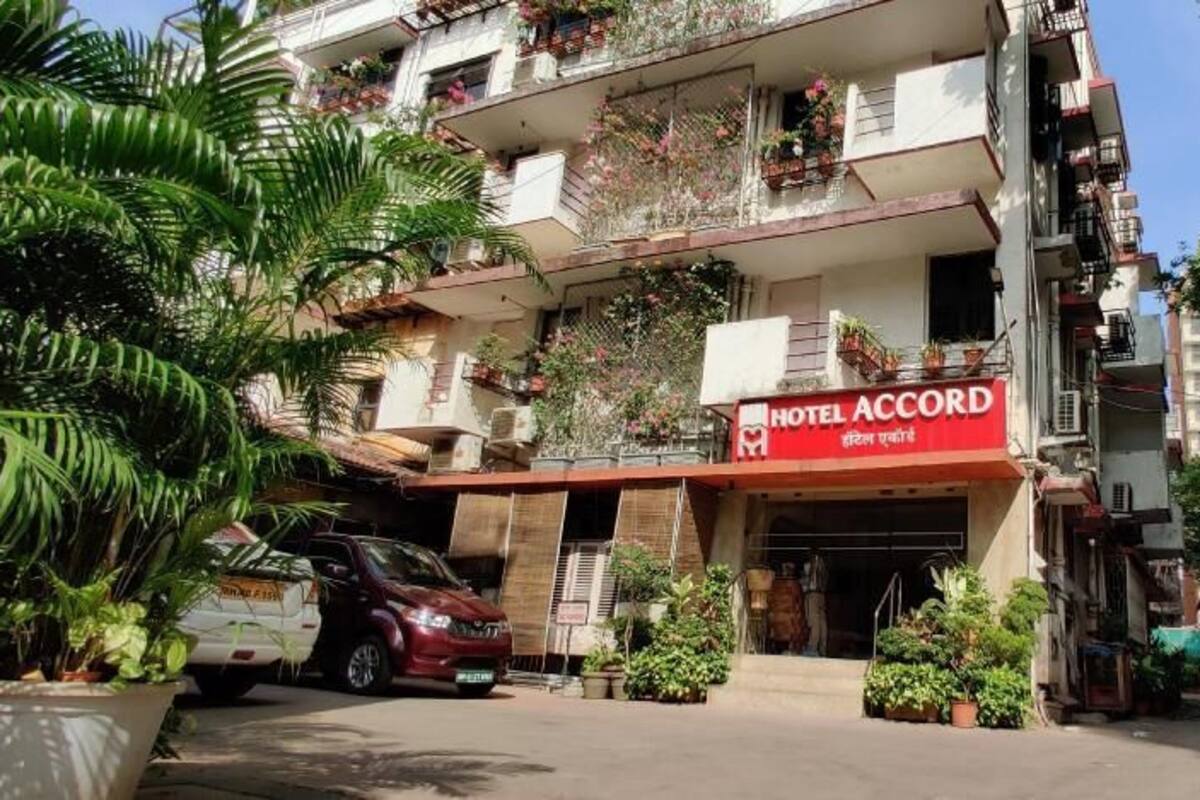 A multi-story building with a sign for 'HOTEL ACCORD' at the entrance.