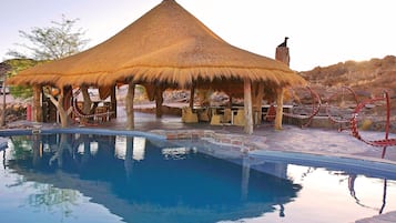 Una piscina al aire libre, tumbonas