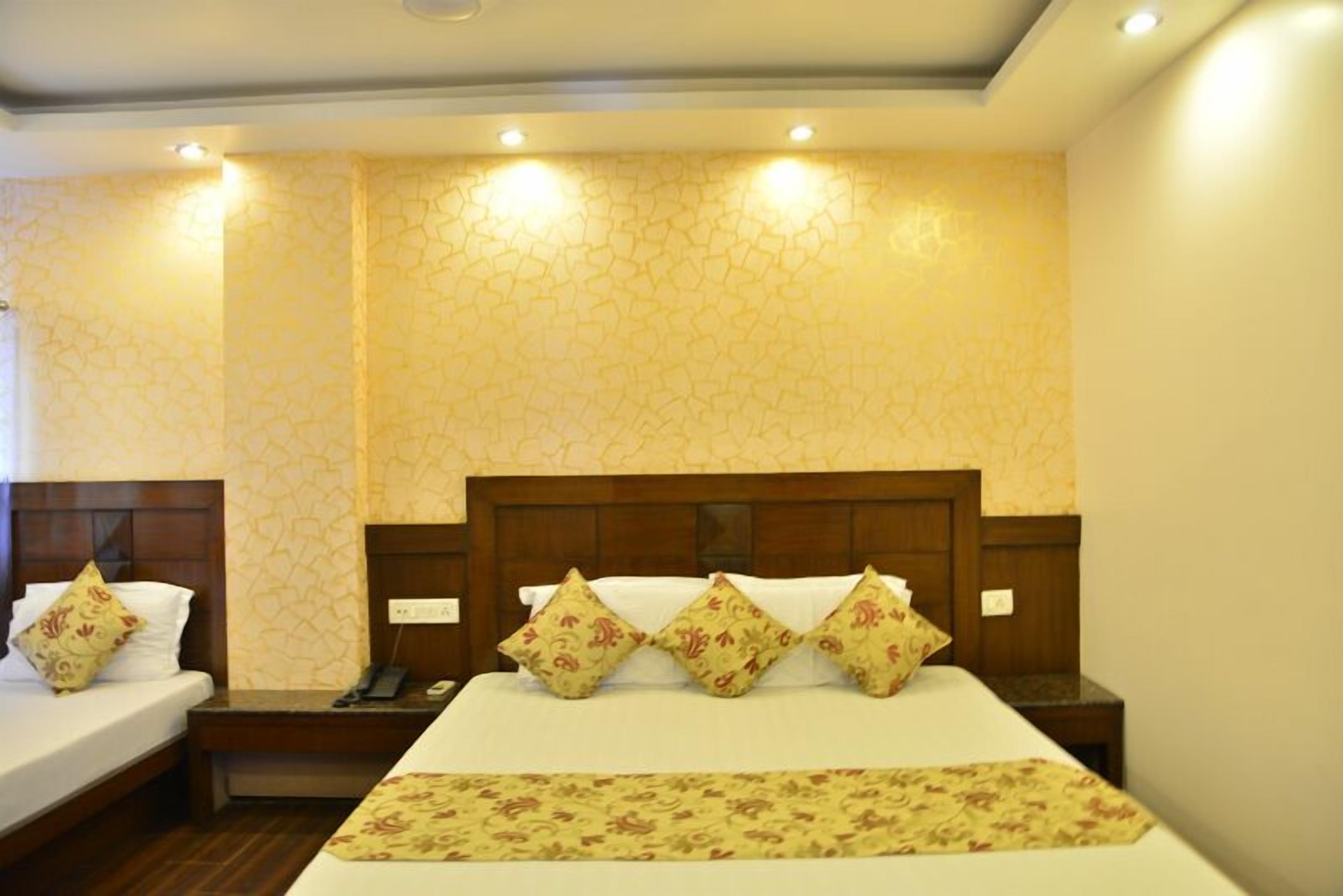 A hotel room with a large bed, two bedside tables, and a nightstand with a phone.