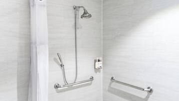 Ducha con cabezal de ducha de mano, accesorio de ducha de mano y barra de apoyo.