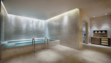 Bathroom features a bathtub, vanity with mirror, and tiled floor.