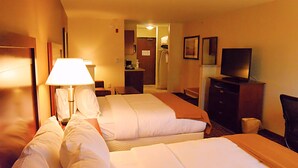 A hotel room with two beds, a desk, a chair, a television, and a bathroom visible through an open door. - Holiday Inn Express & Suites Glendive by IHG (Glendive)
