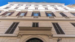 A multi-story building with classical architecture, featuring symmetrical windows and decorative moldings. - Rome55 - Piazza di Spagna (Rome)