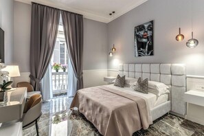 A modern hotel room with a large bed, a desk, and a balcony with plants. - Rome55 - Piazza di Spagna (Rome)
