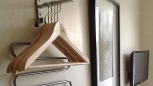 A wall-mounted rack with hangers and a framed picture. - The Stag Enfield (Enfield)