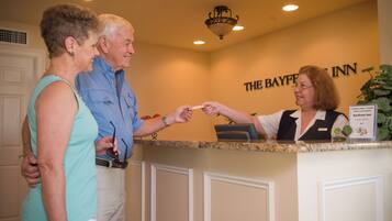 A reception desk at The Bayfront Inn with a sign indicating it is a Superior Small Lodging property.