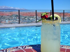 A clear pool with a mountain view in the background.