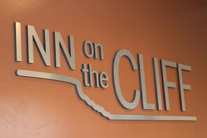 A sign with the text "INN on the CLIFF".