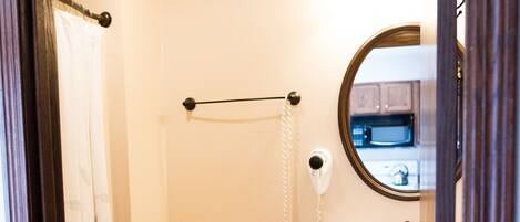 A small bathroom with a toilet, sink, and a mirror.