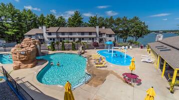 Relax by the resort's central pool, surrounded by lounge chairs and umbrellas, and enjoy the adjacent pool and scenic views.