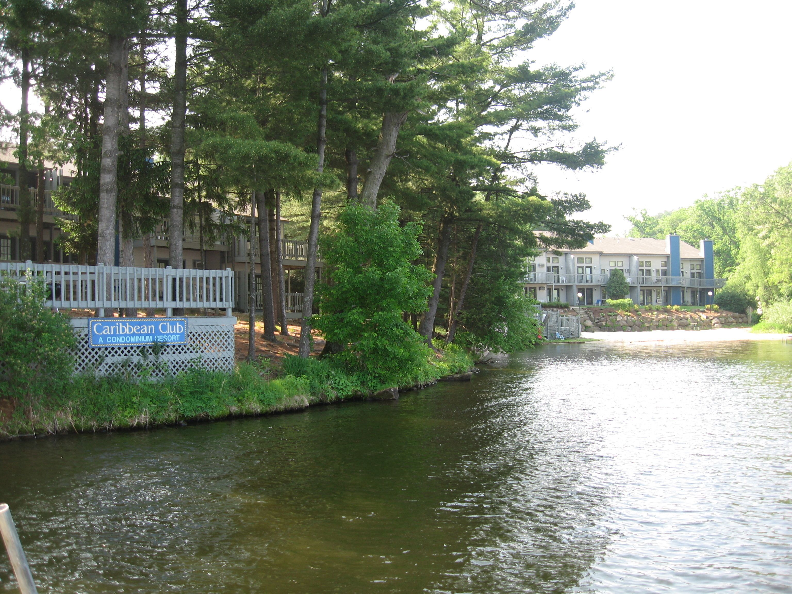 A waterfront condominium resort with a sign reading "Caribbean Club".